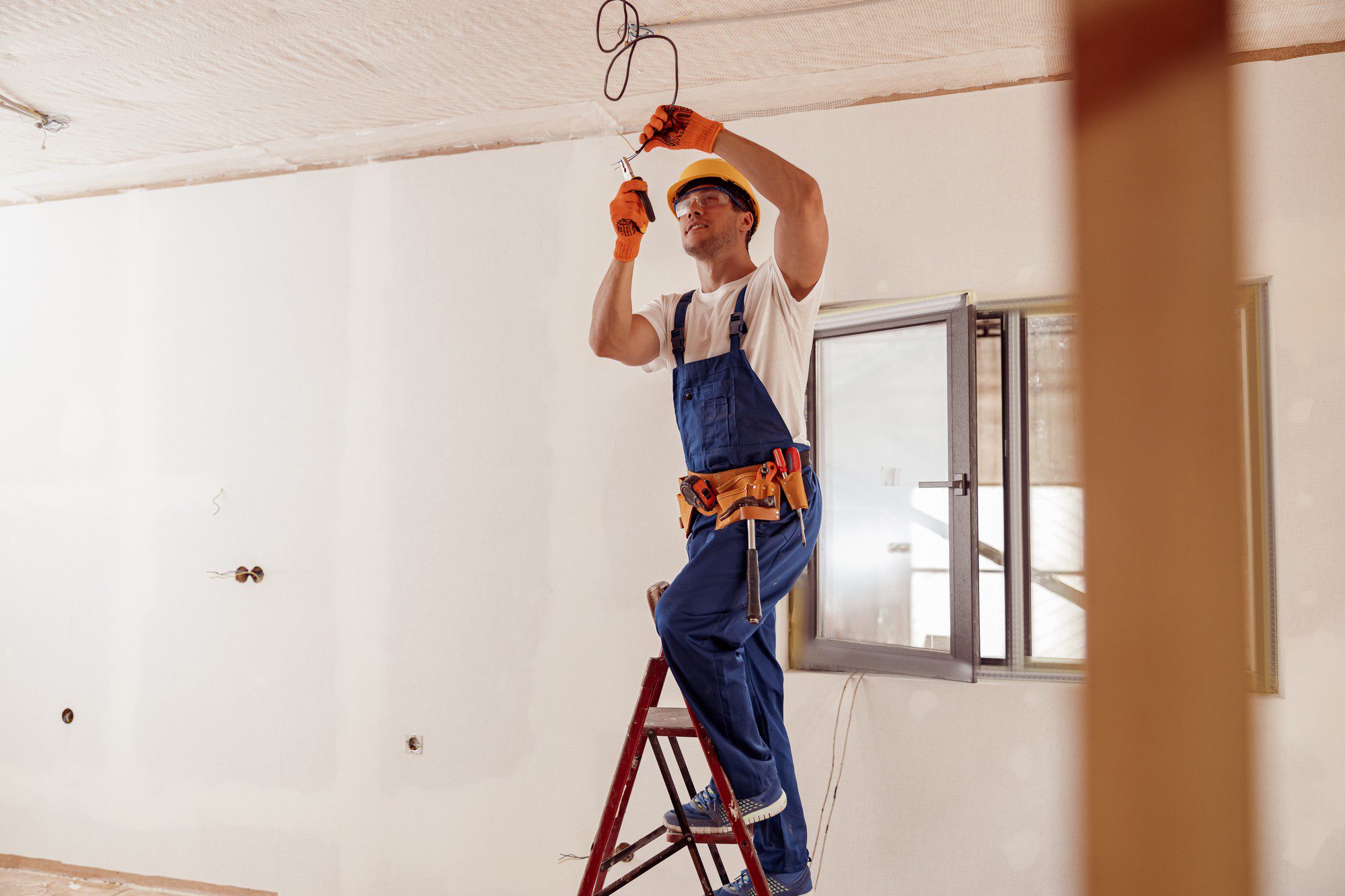 Smiling Electrician Fixing Electric Cable On Ceili 2022 01 04 23 26 18 Utc