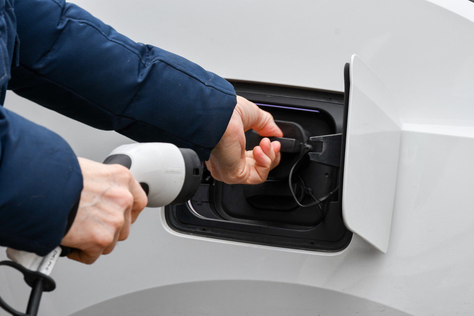 A Man Putting In Charger Cable In Electric Car 2023 11 27 05 07 53 Utc